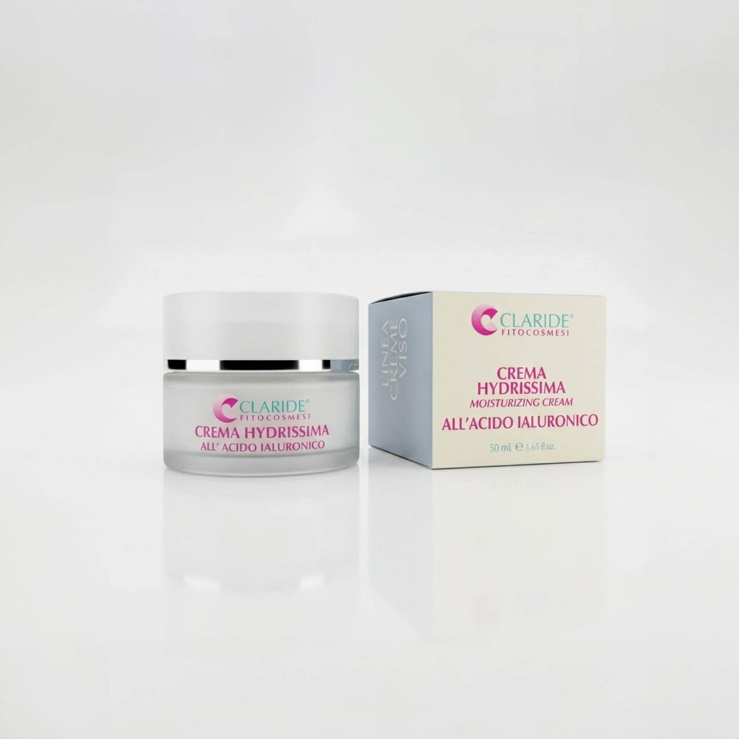 Vasetto in vetro satinato e scatola della Crema Hydrissima di Claride Fitocosmesi. Trattamento viso idratante (Moisturizing Cream) arricchito con Acido Ialuronico per un effetto rimpolpante e fresco, su fondo bianco con riflesso.
