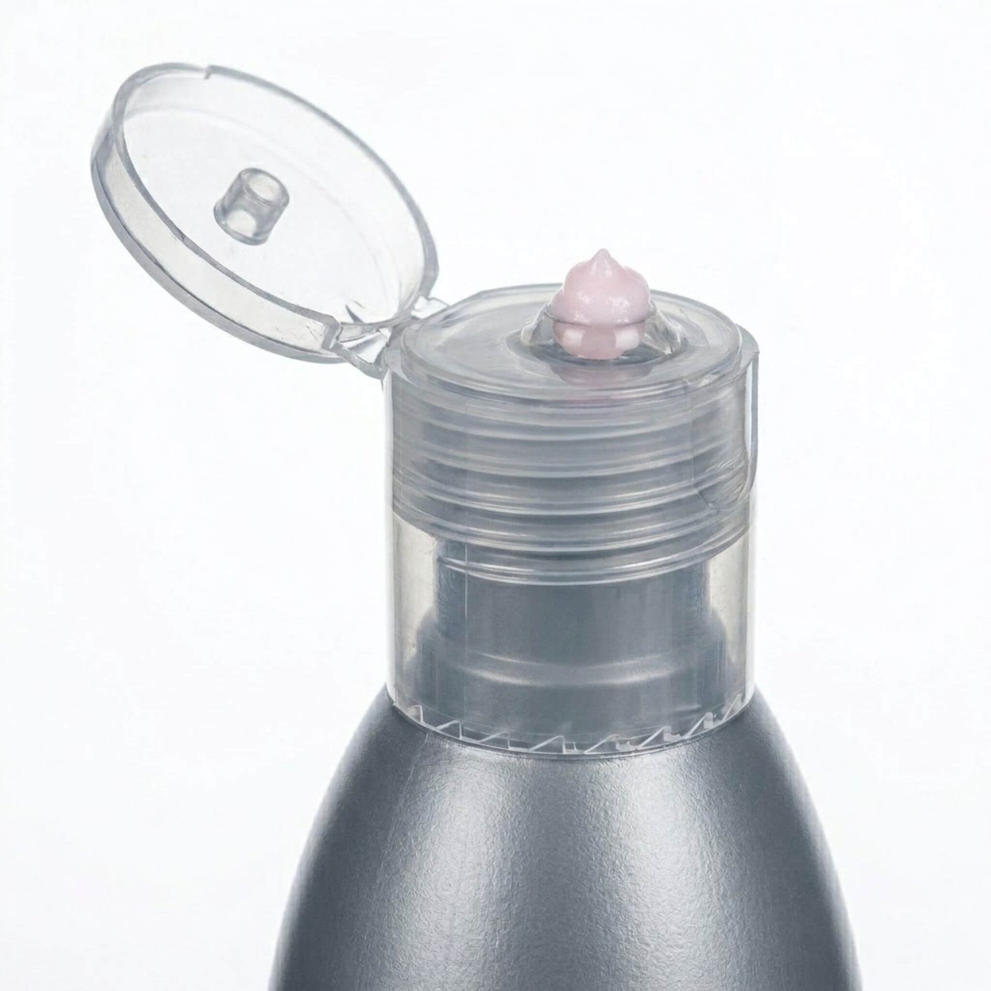 Dettaglio macro dell'erogatore aperto dello Struccante Viso-Occhi Claride Fitocosmesi, con una piccola quantità di crema struccante rosa dalla texture soffice e densa su fondo bianco.