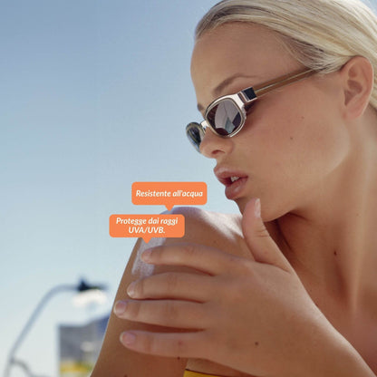 Donna al sole applica sulla spalla la crema solare alta protezione waterproof  Solehado di Claride Fitocosmesi per proteggere la pelle dai raggi UVA/UVB e mantenerla idratata.