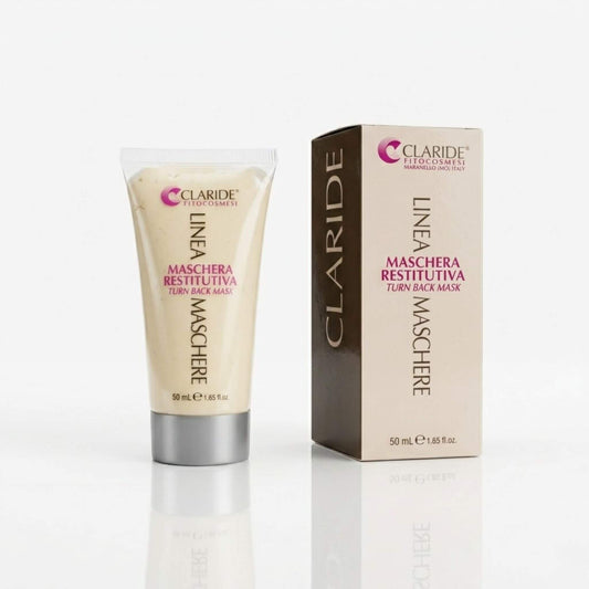 Tubo trasparente con tappo argento che mostra la ricca texture cremosa e scatola della Maschera Restitutiva Claride Fitocosmesi. Trattamento viso intensivo (Turn Back Mask) ad azione anti-age, nutriente e rigenerante, su fondo bianco con riflesso.