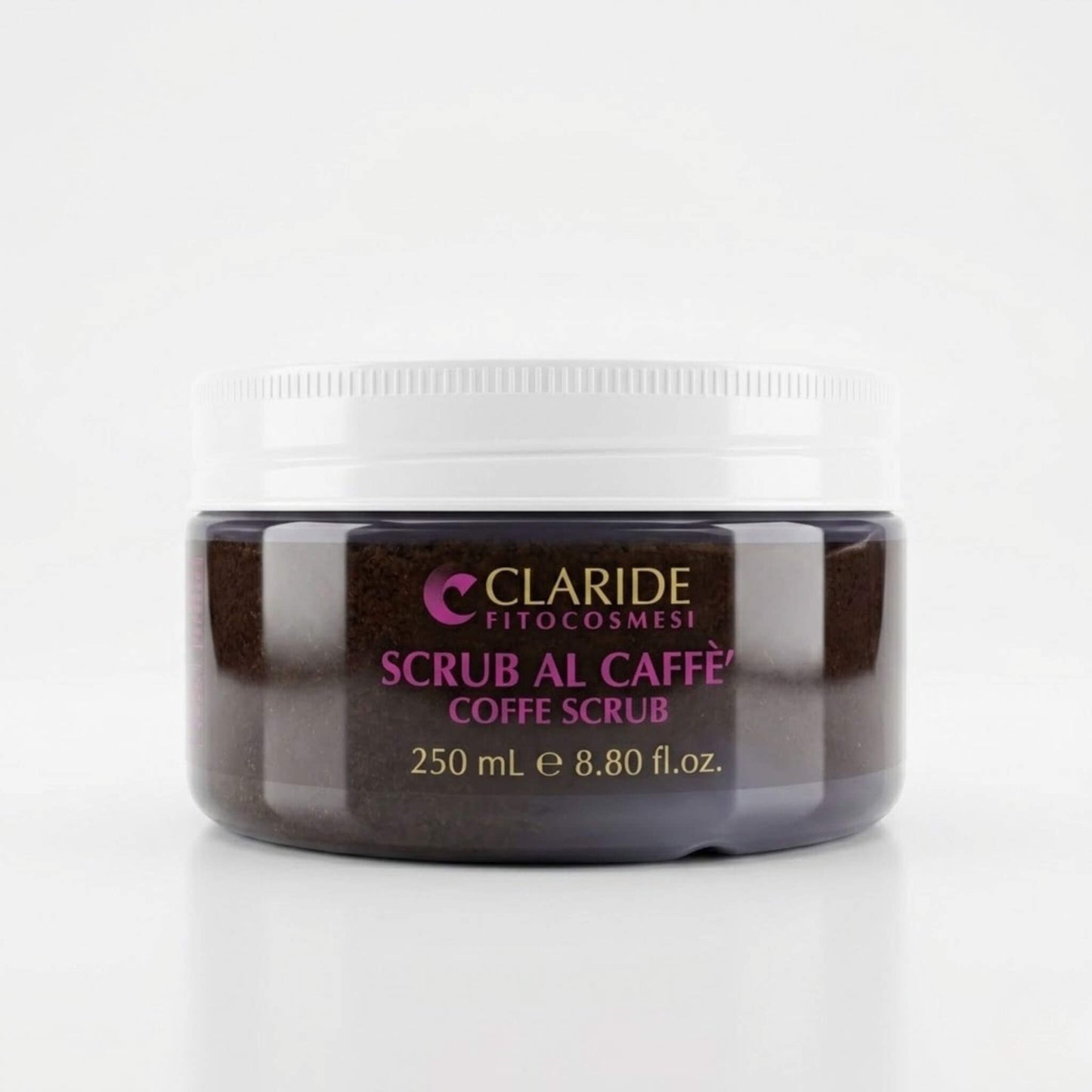Barattolo trasparente da 250ml con tappo bianco che mostra la texture scura e granulosa dello Scrub al Caffè di Claride Fitocosmesi. Trattamento corpo esfoliante (Coffee Scrub) ideale per levigare la pelle e stimolare il microcircolo, su fondo bianco con riflesso.